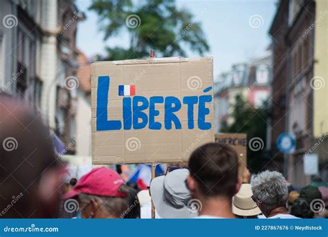 People Protesting In The Street Against The Sanitary Pass With Banner