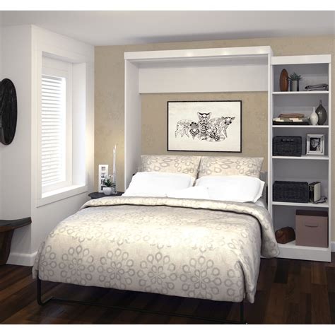 A Bedroom With A Bed Bookshelf And Pictures On The Wall Above It