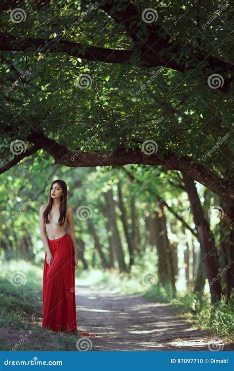 Photo Of Fashion Woman With Naked Breast In Red Dress In Fairy Forest Stock Photo Image Of