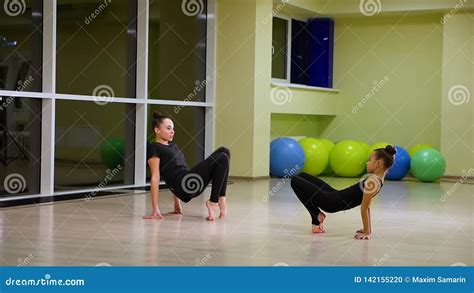 Two Slim Cute Girls Sisters Artistic Gymnasts In Black Sportswear Make