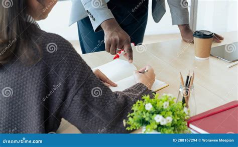 Mature Professor Talking To His Student While Assisting Her On A Class At The University Stock