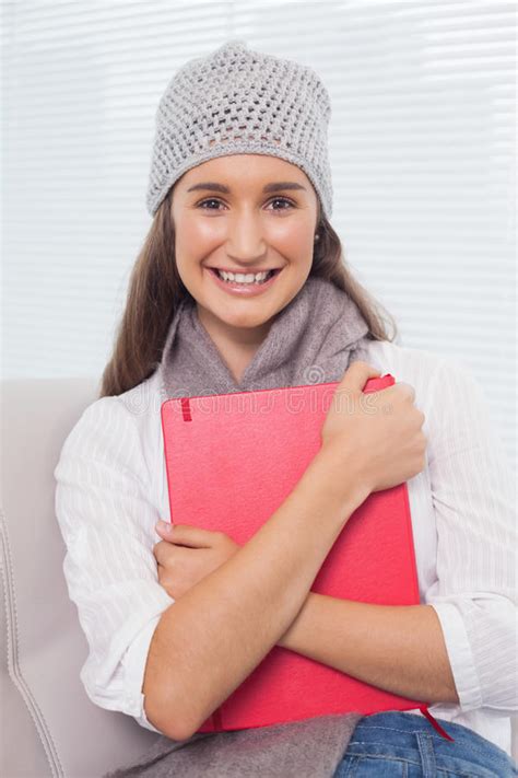 Cheerful Brunette With Winter Hat On Holding Folder Stock Image Image Of Couch Living 33526409
