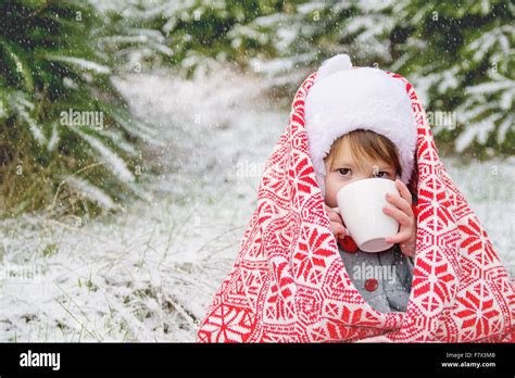 Girl Drinking Hot Cocoa In The Snow Stock Photo Alamy