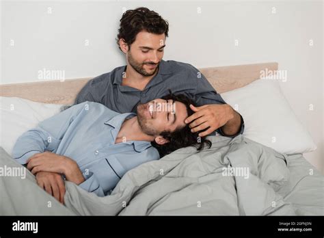 Gay Man Stroking Hair Of Boyfriend In Bed Stock Photo Alamy