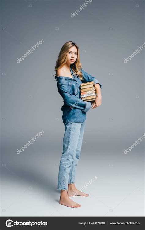 Sexy Barefoot Woman Denim Clothes Naked Shoulder Holding Stack Books Stock Photo