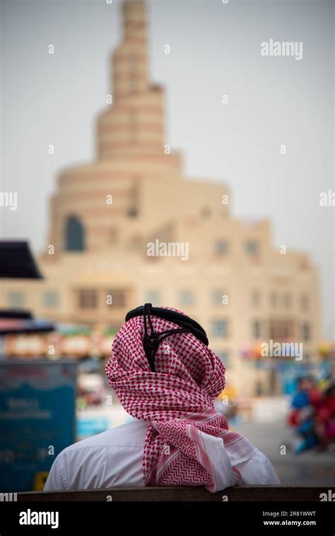 Backside View Of Men In Its Cultural Headdress Facing Al Fanar At Doha
