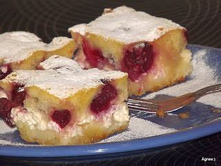 Two Pieces Of Cake On A Blue Plate With A Fork Next To It And Some