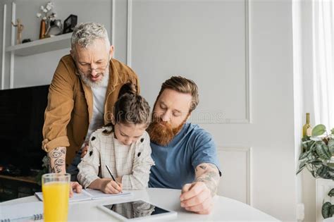 Gay Fathers Looking At Daughter Doing Stock Image Image Of Notebooks Dads