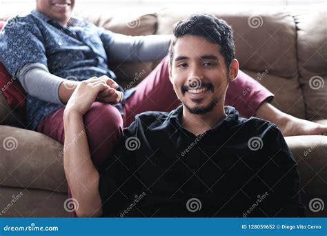 Hispanic Gay Couple Holding Hands On Sofa At Home Stock Photo Image Of Hands Diversity 128059652