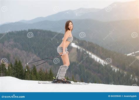 Beautiful Naked Female Skier Skiing On The Snowy Slope Of The Mountain