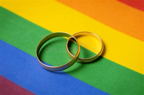 Same Sex Marriage Concept Wedding Rings On Lgbt Rainbow Flag Stock Photo Image Of