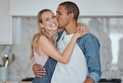 Love Interracial And Couple Kiss In Kitchen Happiness And Loving Together For Relationship