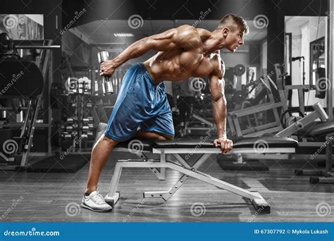 Muscular Man Working Out In Gym Doing Exercises With Dumbbells At Triceps Strong Male Naked