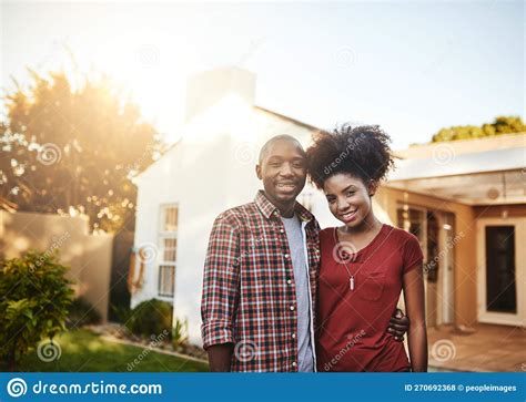 Proud First Time Homeowners Portrait Of A Young Couple Standing