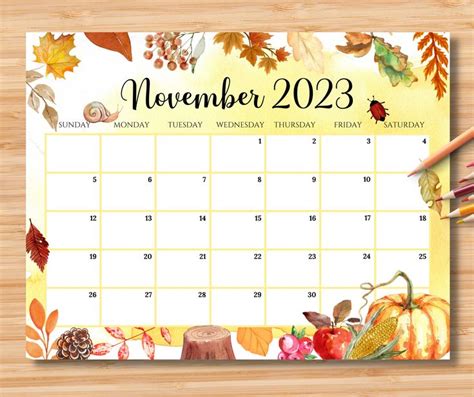 A Desk Calendar With Autumn Leaves And Acorns On It Next To A Pencil