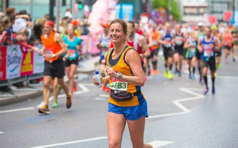 happy marathon runner cheering  public charity money raise london