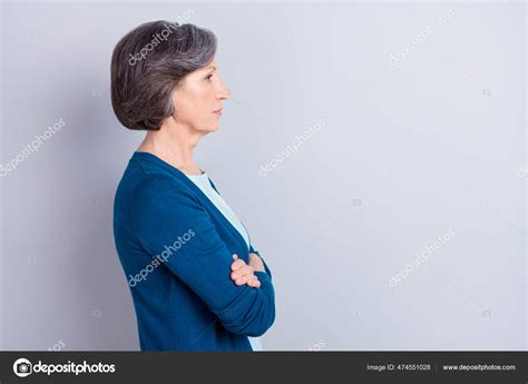 Photo Of Serious Pretty Mature Lady Dressed Blue Outfit Hands Crossed Looking Empty Space