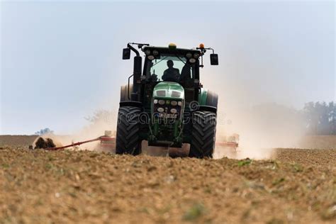 A Farmer Working on the Field with a John Deere Tractor Editorial Stock ...