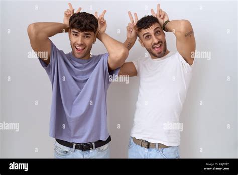 Homosexual Gay Couple Standing Over White Background Posing Funny And