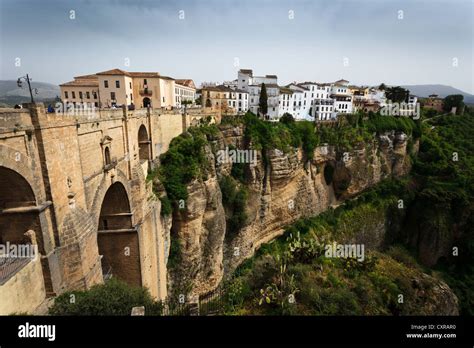 View of cliff, 18th century bridge, and city buildings above the Tajo ...