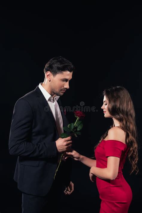 Handsome Man Presenting Red Rose To Woman In Red Dress Isolated Stock