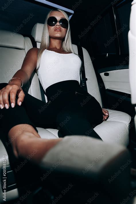 Blonde With Long Legs In A Leather White Salon Blonde In Car Blonde With Glasses Girl With Long