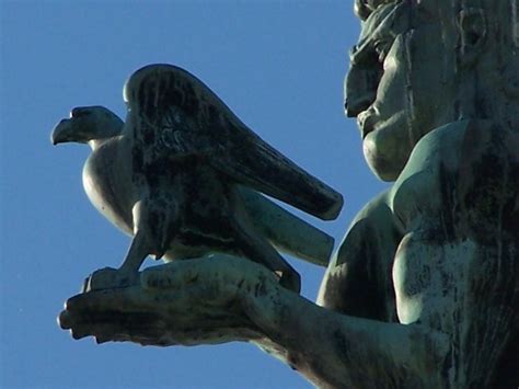 The Statue Is Holding Two Birds In His Hands And Looking Up At The Sky