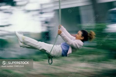side profile   girl swinging   swing superstock