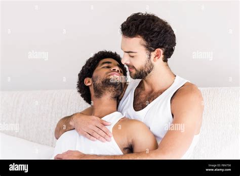 Happy Gay Couple Cuddling On Bed Stock Photo Alamy