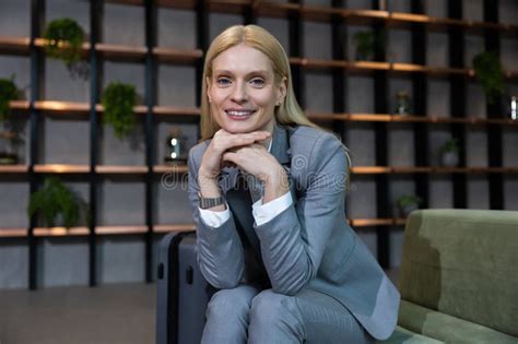 Pretty Long Haired Blonde Caucasian Woman In A Nice Suit Looking Contented Stock Photo Image