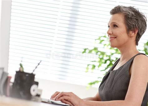 Shes Great At Managing Her Time A Mature Businesswoman At Work In Her Office Stock Image