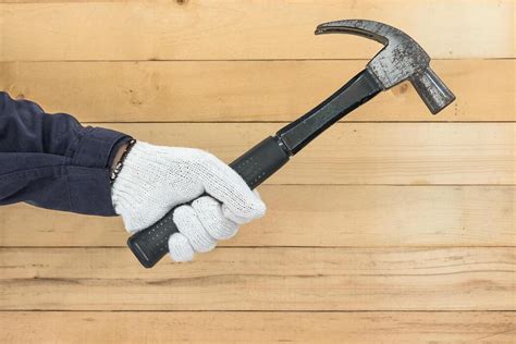 hand holding hammer stock  images  backgrounds
