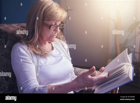 Senior Blonde Woman Reading A Book Stock Photo Alamy