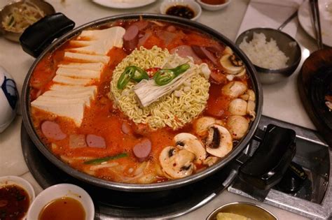 Premium Photo Korean Hot Pot Served With Kimchi Sausages Spam Ramen Noodles Tofu For Food
