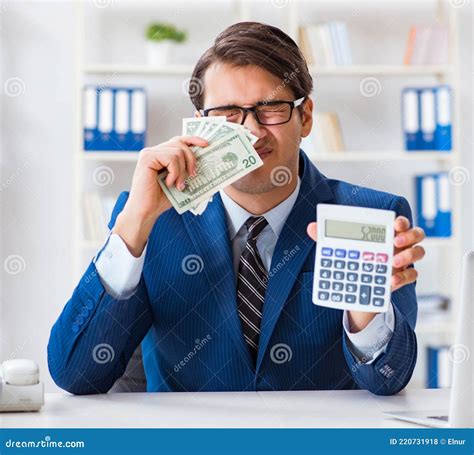 Accountant Calculating Dollars with Calculator in Office Stock Photo