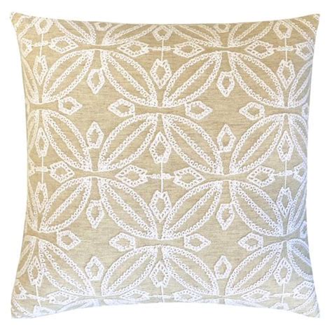 A Beige And White Pillow With An Intricate Design On The Front Side