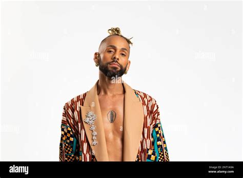 Confident Black Gay Man Standing Isolated On White Background Dressed In A Bold Colorful