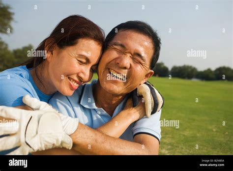 Close Up Of A Mature Woman Hugging A Mature Man And Smiling Stock Photo Alamy
