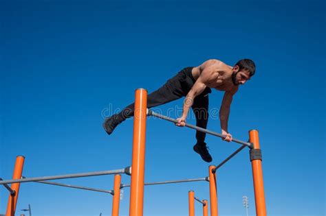 A Man With A Naked Torso Makes A Balance On The Horizontal Bar Stock Photo Image Of Athlete