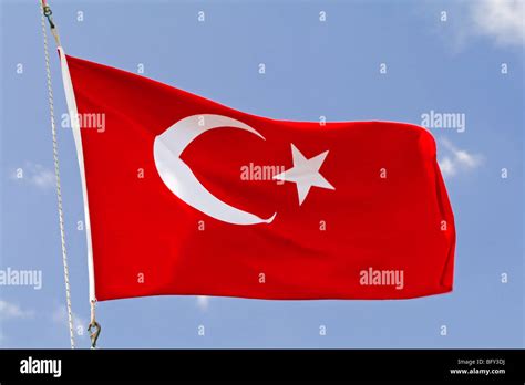 The Flag Of Turkey Red With A White Crescent Moon And A Star In Its