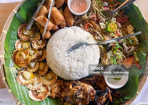 filipino food   plate   banana leaf base rice chicken lumpia