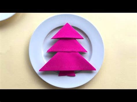 A Pink Paper Christmas Tree On A White Plate