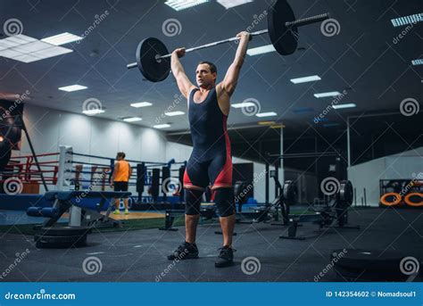 Powerlifter Doing Weightlifting Exercise Man With Naked Torso Lifting