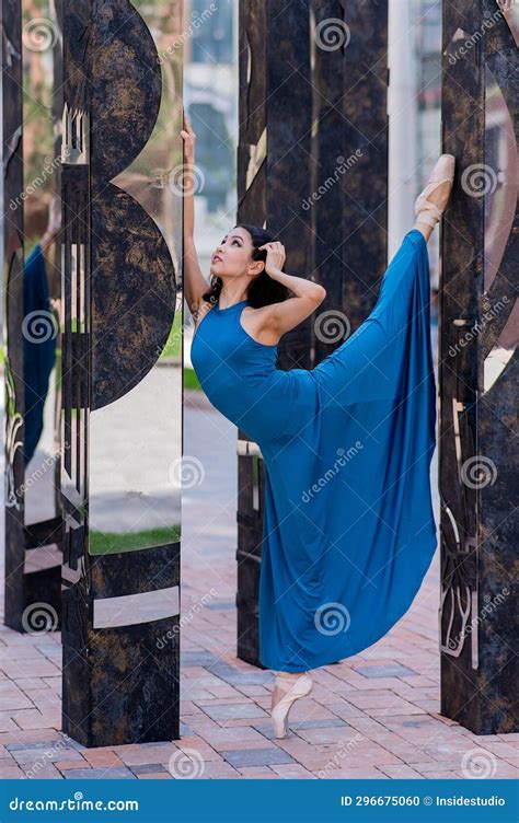 Beautiful Asian Ballerina In Blue Dress And Pointe Shoes Posing