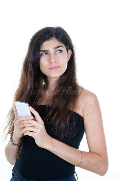Beauty Woman With Long Hair Brunette Holding A Phone Smartphone In Hand Look Side Stock Photo