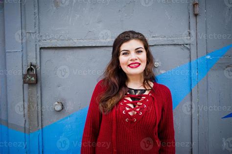 Brunette Plus Size Model At Red Against Colored Wall 10579547 Stock