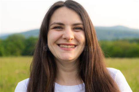 Portrait Of A Year Old Brunette Woman Looking At The Camera Smiling In Nature Stock Image