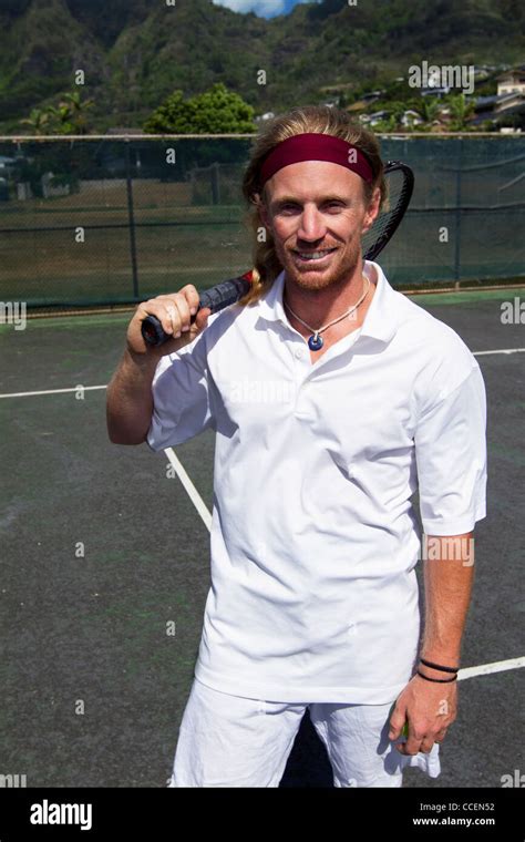 A Handsome Blonde Tennis Player Poses With His Racquet On The Court Stock Photo Alamy