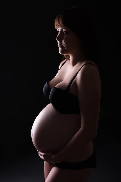 Premium Photo Pregnant Woman Posing In Lingerie Over Black Background