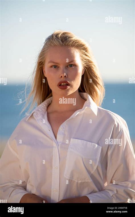 Perfect Imperfection Caucasian Curvy Model With Blonde Hair And White Shirt In Sunlight